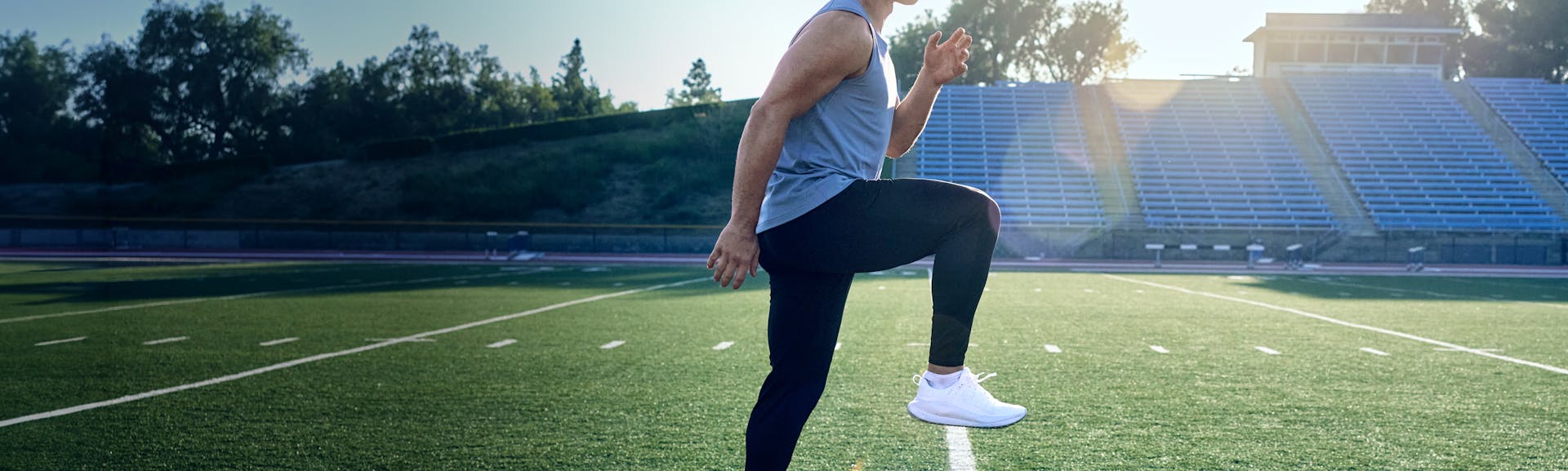 Christian McCaffrey stretching on the practice field