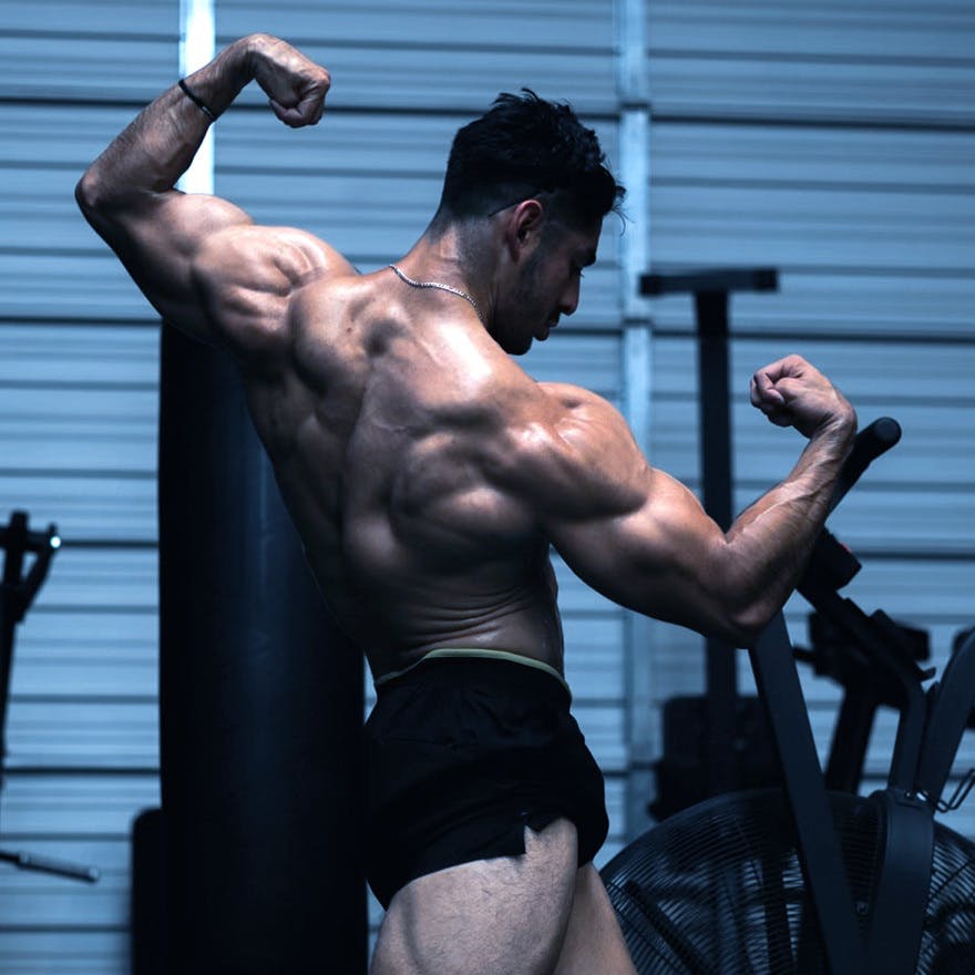 Christian Romo flexing in a gym.