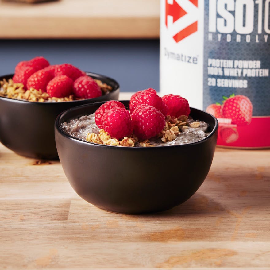 Berry High Protein & Fiber Chia Yogurt Bowls with a tub of Dymatize ISO100 Strawberry Protein Powder